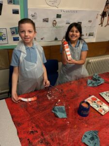 Mixing paints to create different shades of colour.