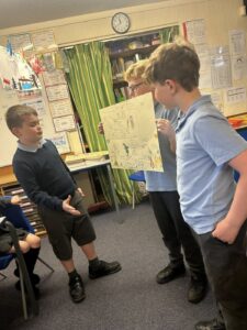 Children use their oracy skills to present their story boards to the rest of the class.